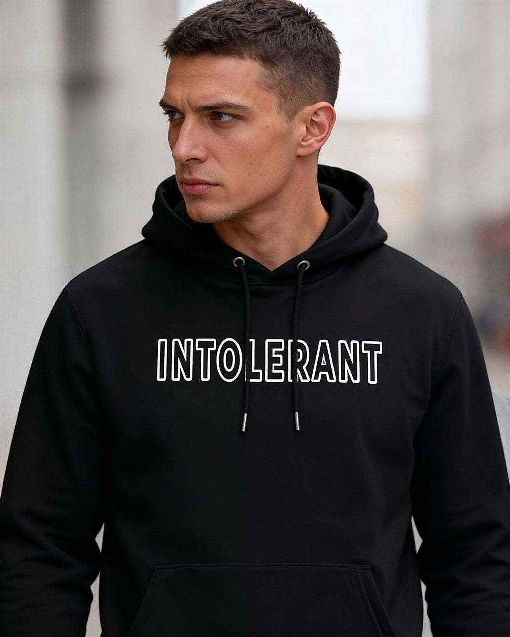 Lifestyle-Bild eines jungen Mannes im schwarzen INTOLERANT Classic Hoodie – verkörpert Standhaftigkeit und Selbstbewusstsein.